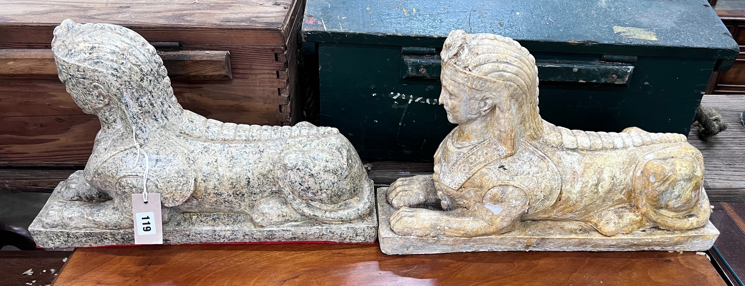 A pair of composition faux marble sphinx, length 48cm, height 30cm *Please note the sale commences at 9am.